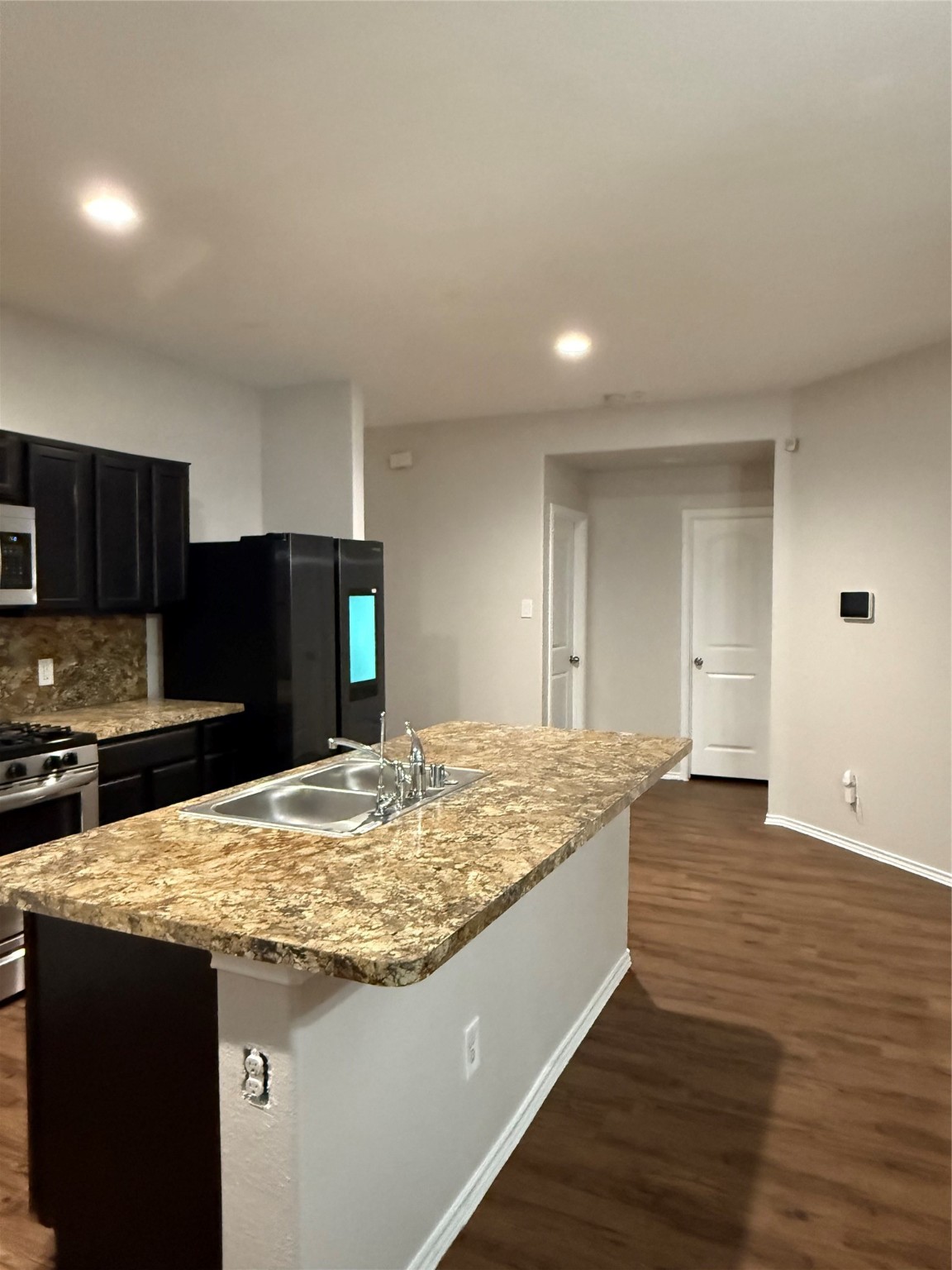 15415 Bosque Viejo Trail Channelview, TX 77530 - Photo 6 of 20 a kitchen with kitchen island sink and refrigerator