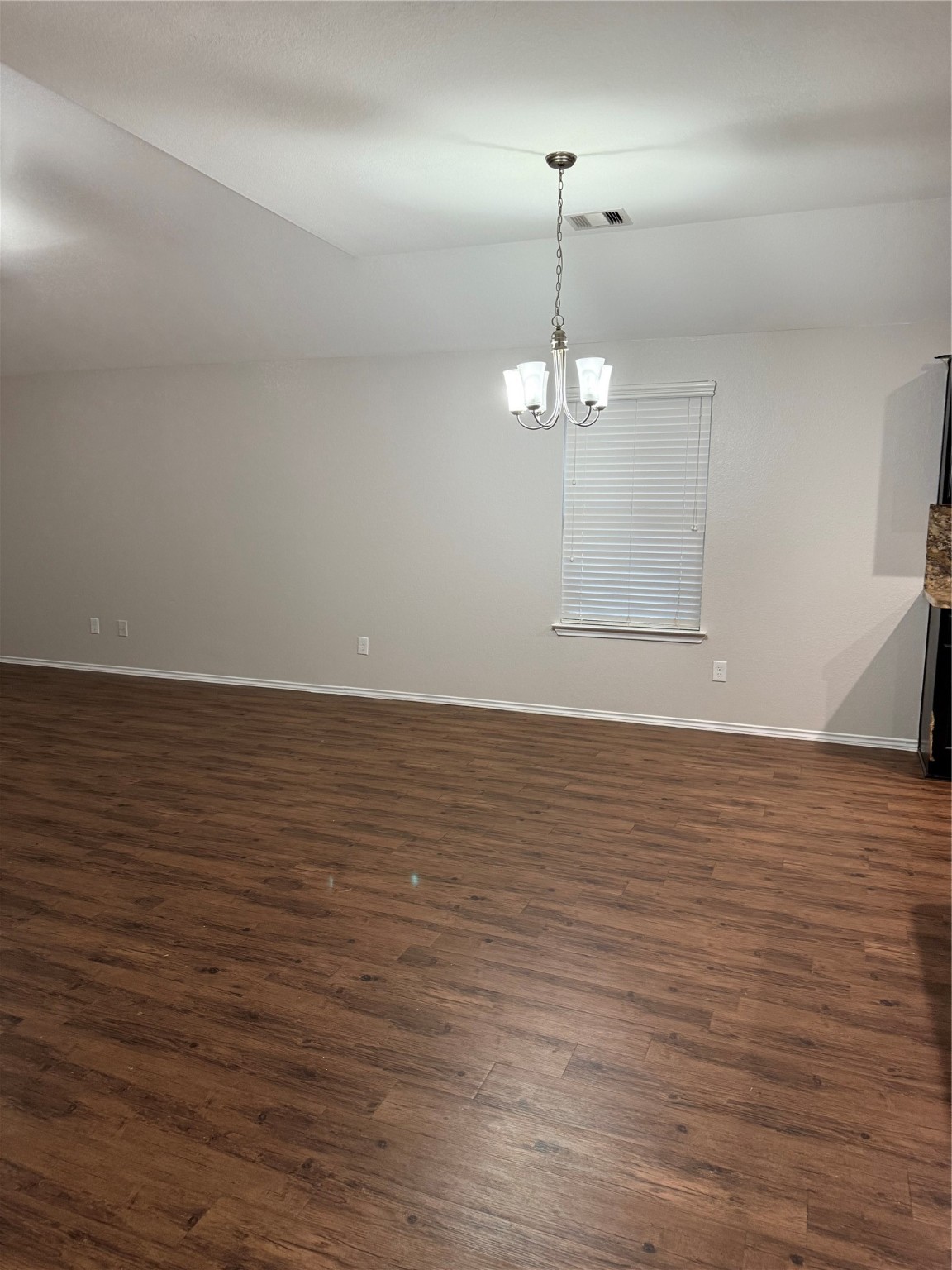 15415 Bosque Viejo Trail Channelview, TX 77530 - Photo 9 of 20 an empty room with wooden floor chandelier fan and window