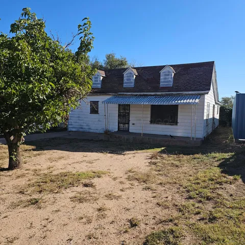 a view of house with snow on the road