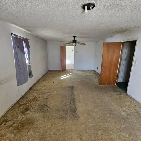 an empty room with windows and closet