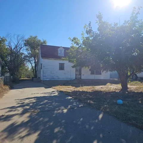 a backyard of a house with table and chairs