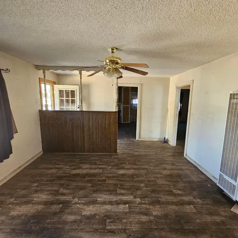 a view of kitchen with granite countertop lots of stainless steel appliances