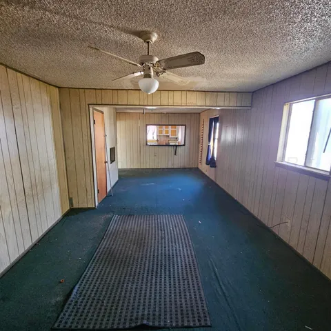 an empty room with windows & yard