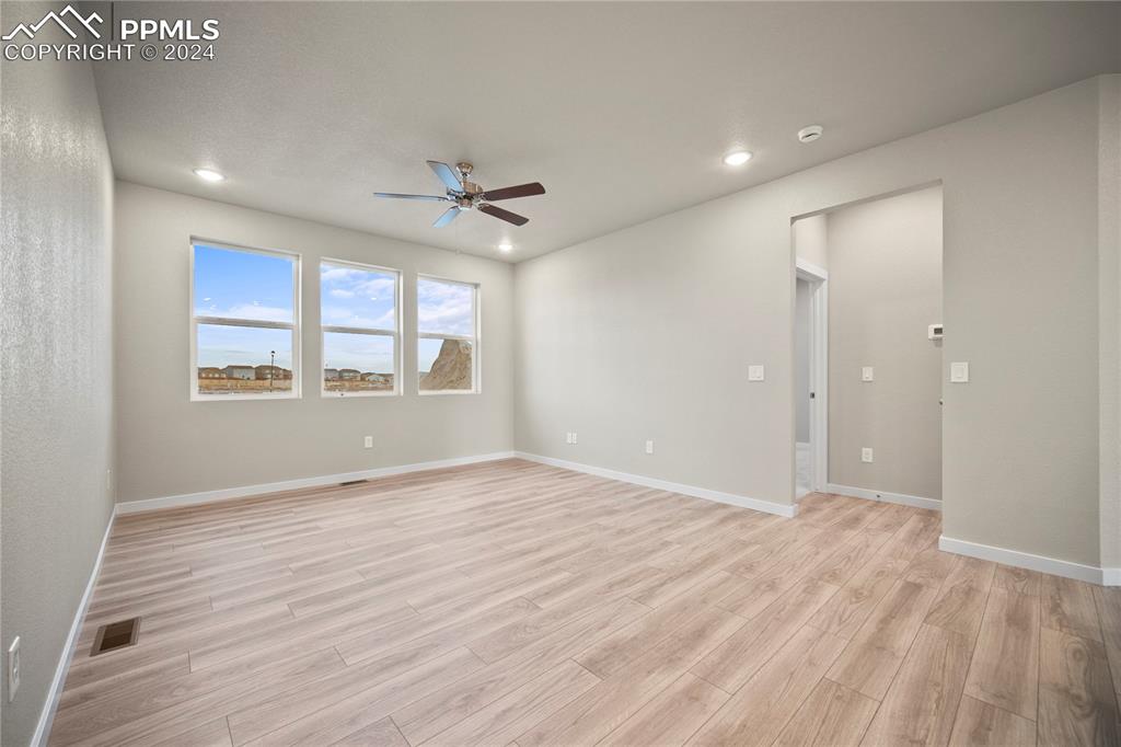 8093 Yellowleaf Place Colorado Springs, CO 80908 - Photo 15 of 23 a view of an empty room with a window and wooden floor