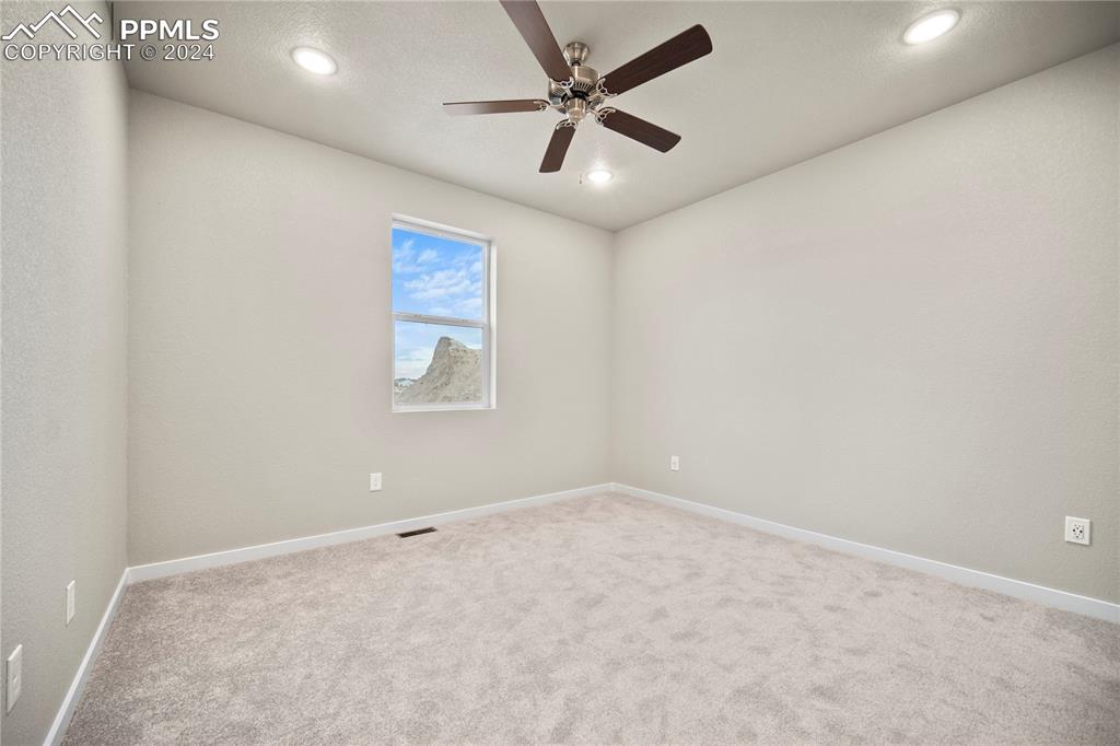 8093 Yellowleaf Place Colorado Springs, CO 80908 - Photo 17 of 23 en empty room with windows and fan