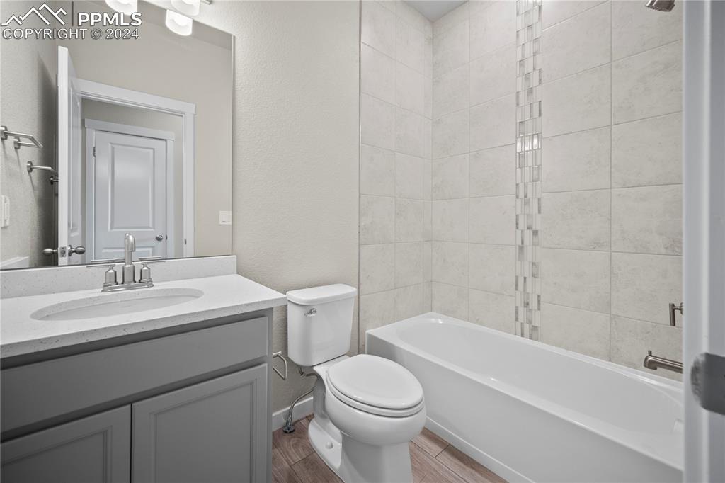 8093 Yellowleaf Place Colorado Springs, CO 80908 - Photo 19 of 23 a bathroom with a sink toilet vanity and shower