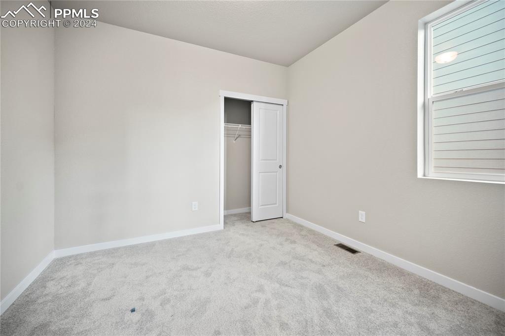 8093 Yellowleaf Place Colorado Springs, CO 80908 - Photo 20 of 23 a view of an empty room with a window