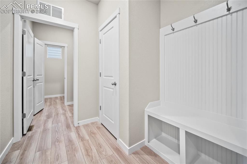 8093 Yellowleaf Place Colorado Springs, CO 80908 - Photo 21 of 23 a view of a hallway with wooden floor and closet