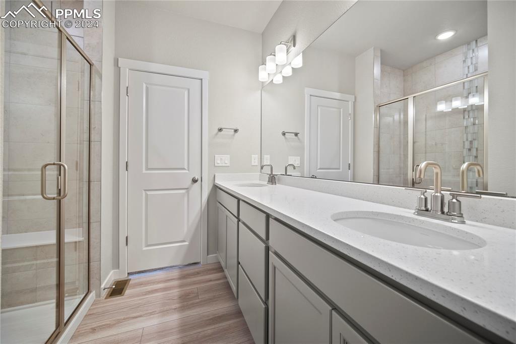 8093 Yellowleaf Place Colorado Springs, CO 80908 - Photo 8 of 23 a bathroom with double vanity sinks and a mirror