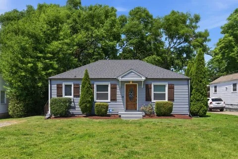 a front view of a house with a garden