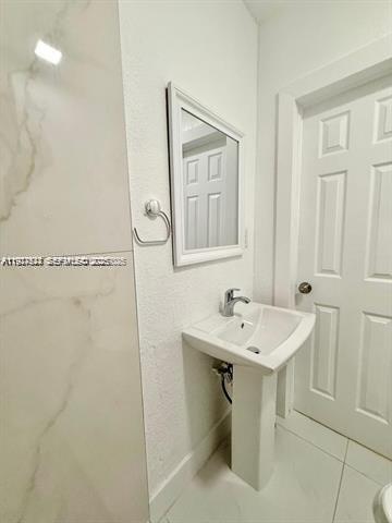 2369 Southwest 17th Terrace, Unit 2369 Miami, FL 33145 - Photo 19 of 25 a bathroom with a sink a toilet and mirror