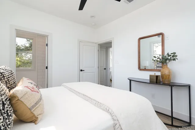 a bedroom with a bed and a chandelier