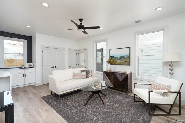 a living room with furniture and a wooden floor