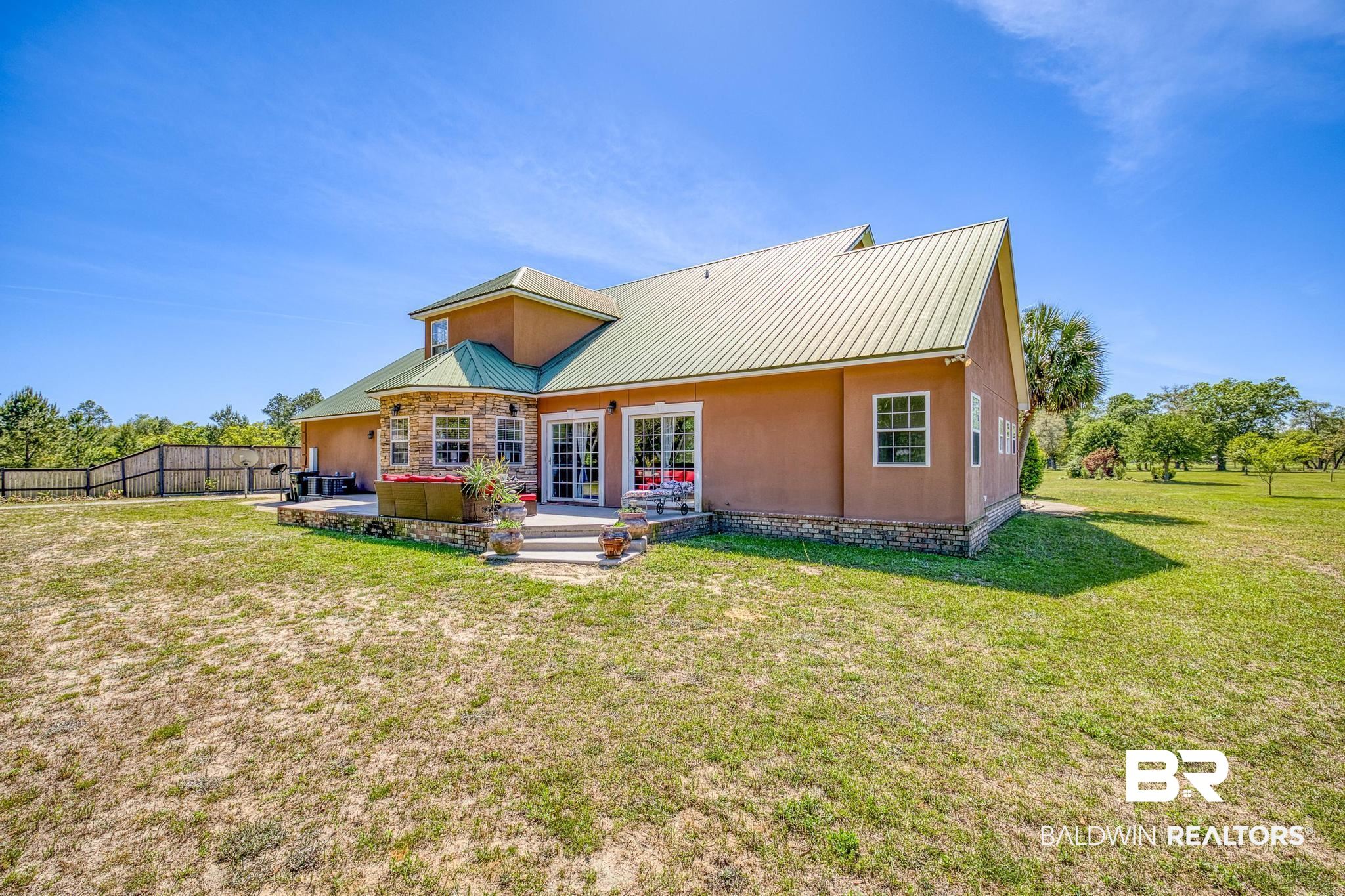 32875 Faircloth Road Lillian, AL 36549 - Photo 58 of 85 Back of property featuring a patio area and a metal roof