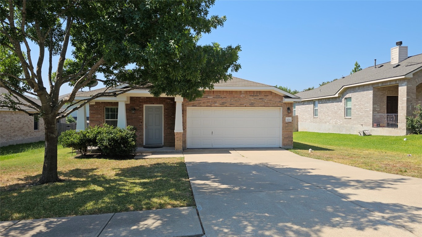 3708 Hawk View Street Round Rock, TX 78665 - Photo 1 of 12 a front view of a house with a yard and garage