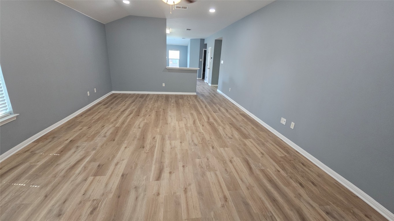 3708 Hawk View Street Round Rock, TX 78665 - Photo 2 of 12 a view of a room with wooden floor and window