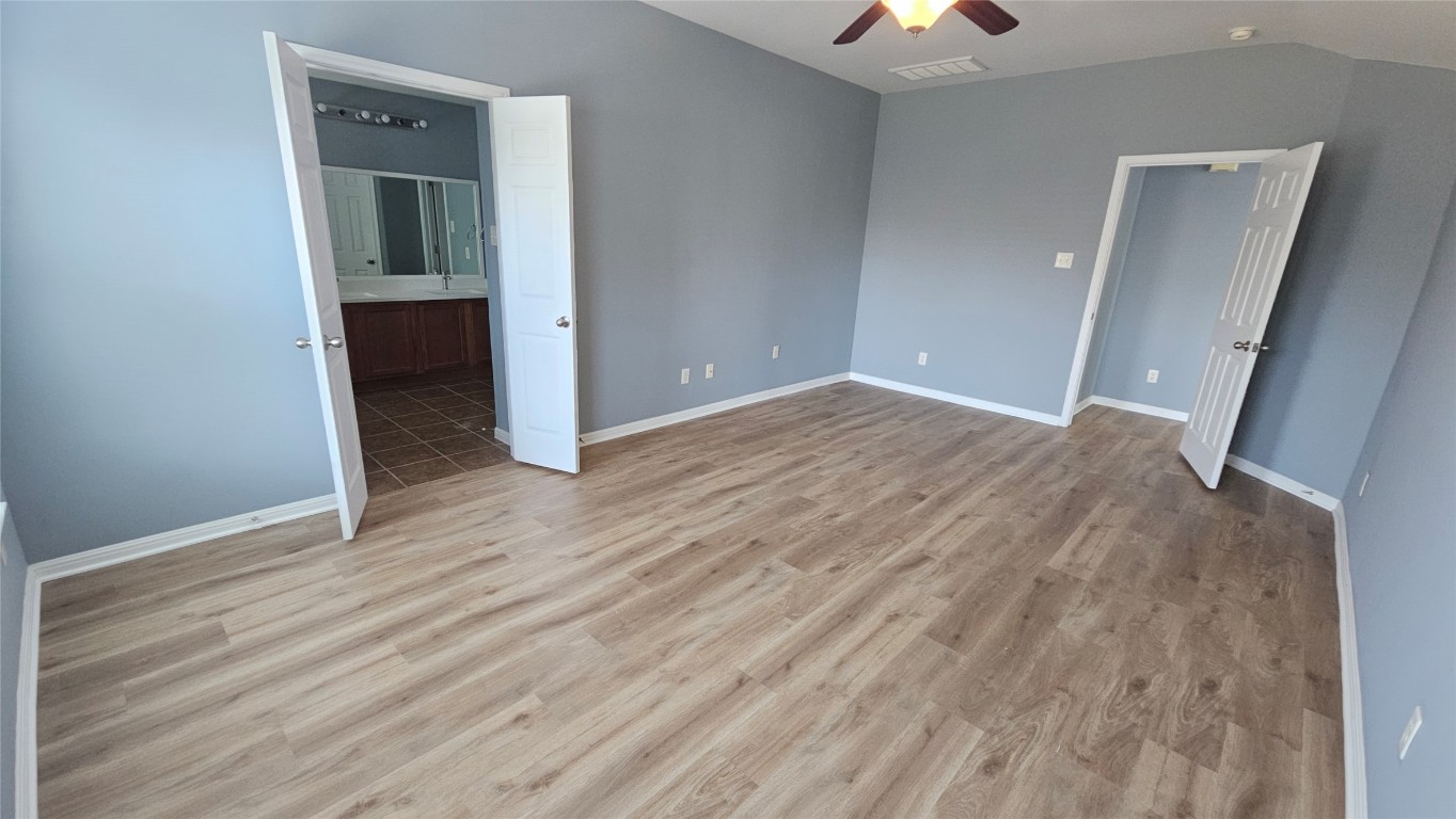 3708 Hawk View Street Round Rock, TX 78665 - Photo 6 of 12 wooden floor in an empty room with a window