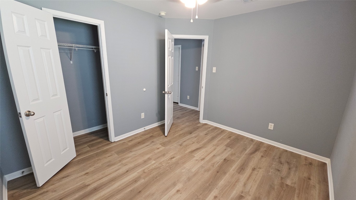 3708 Hawk View Street Round Rock, TX 78665 - Photo 9 of 12 an empty room with wooden floor and entrance