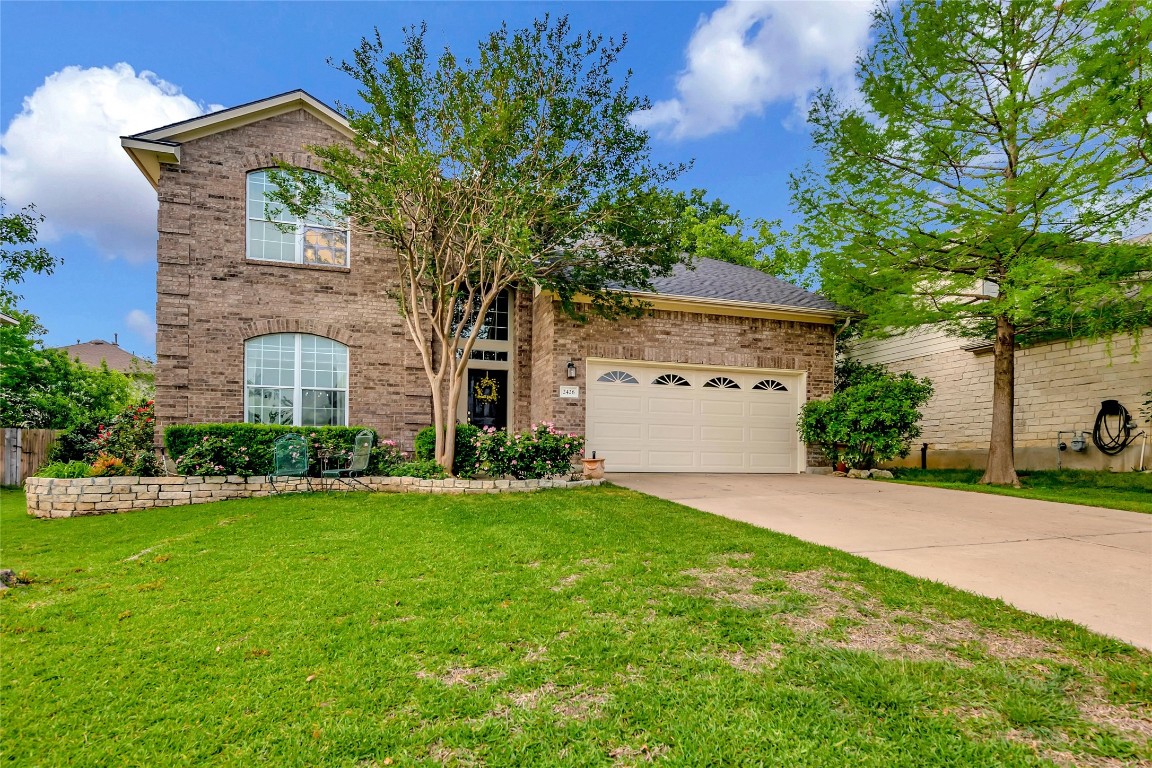 2426 Candle Ridge Trail Georgetown, TX 78626 - Photo 1 of 1 a front view of a house with a garden and trees