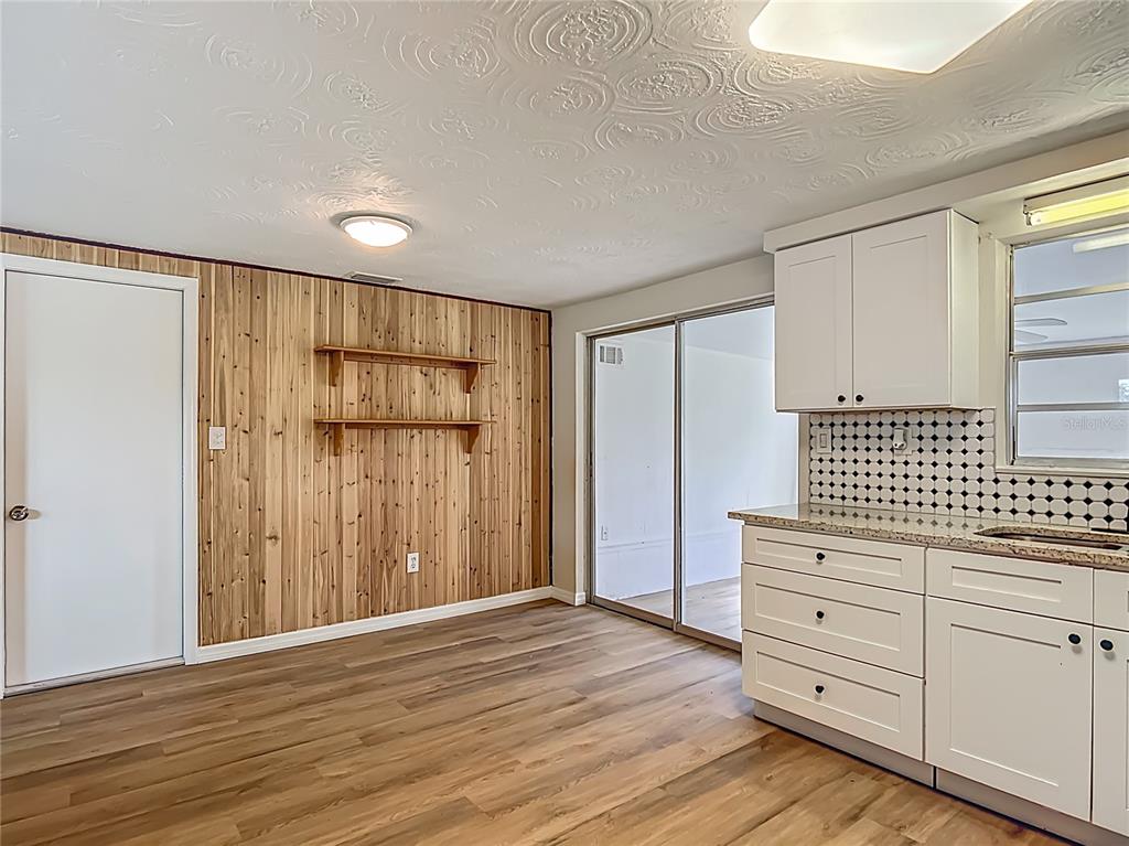 6632 Sierra Terrace New Port Richey, FL 34652 - Photo 11 of 49 a view of a room with wooden floor and cabinet