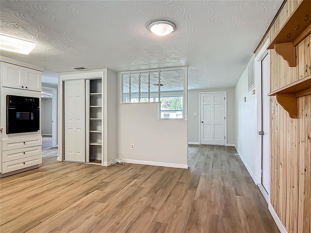 6632 Sierra Terrace New Port Richey, FL 34652 - Photo 13 of 49 an empty room with wooden floor and windows