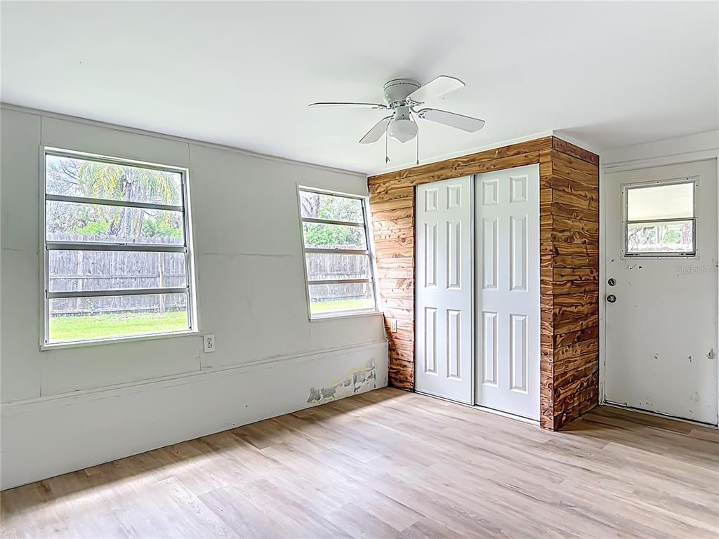 6632 Sierra Terrace New Port Richey, FL 34652 - Photo 15 of 49 an empty room with wooden floor fan and windows