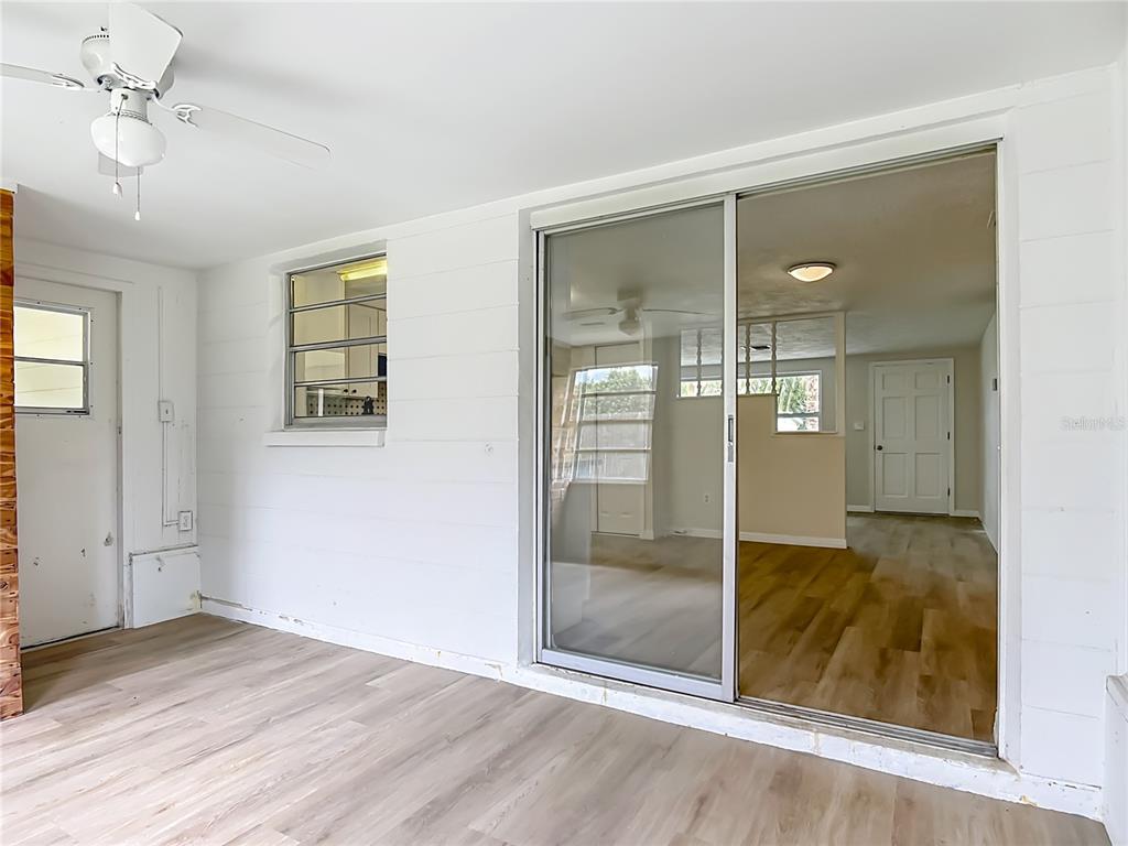 6632 Sierra Terrace New Port Richey, FL 34652 - Photo 16 of 49 an empty room with wooden floor mirror and windows
