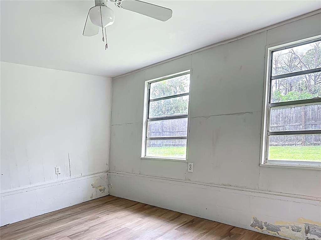 6632 Sierra Terrace New Port Richey, FL 34652 - Photo 18 of 49 a view of an empty room with wooden floor and a window