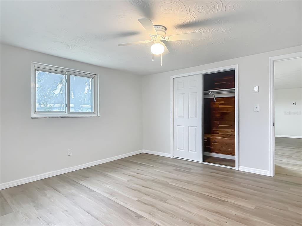 6632 Sierra Terrace New Port Richey, FL 34652 - Photo 20 of 49 wooden floor in an empty room with a window