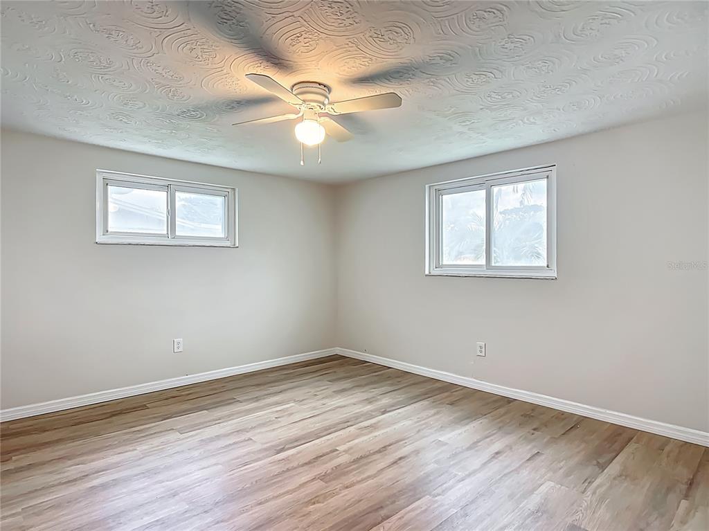 6632 Sierra Terrace New Port Richey, FL 34652 - Photo 21 of 49 a view of an empty room with wooden floor and a window