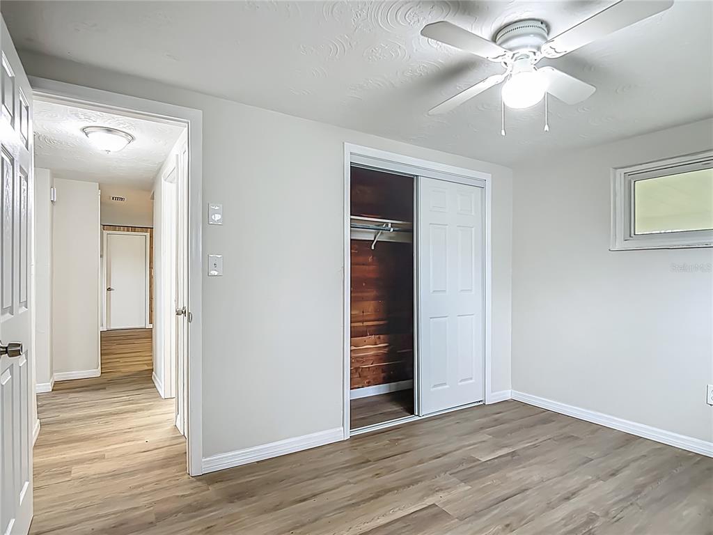 6632 Sierra Terrace New Port Richey, FL 34652 - Photo 22 of 49 wooden floor in an empty room with a window