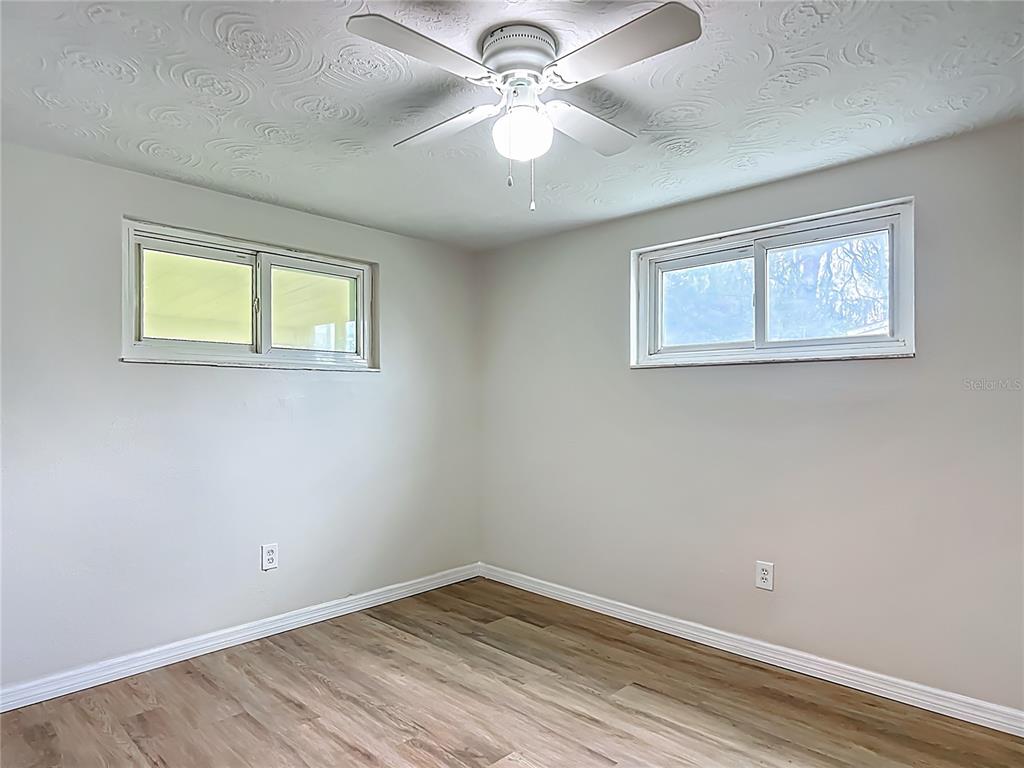 6632 Sierra Terrace New Port Richey, FL 34652 - Photo 24 of 49 a view of a big room with windows and chandelier fan