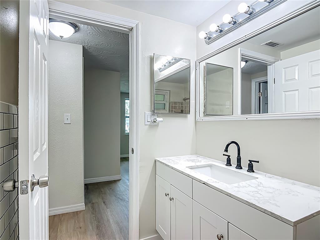 6632 Sierra Terrace New Port Richey, FL 34652 - Photo 26 of 49 a bathroom with a sink vanity granite and a mirror