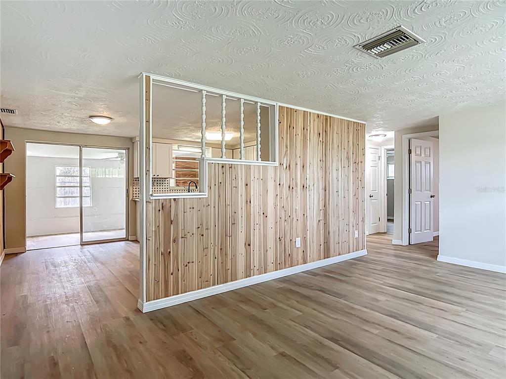6632 Sierra Terrace New Port Richey, FL 34652 - Photo 6 of 49 an empty room with wooden floor and windows