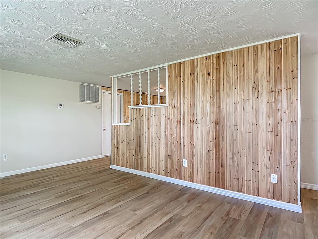 6632 Sierra Terrace New Port Richey, FL 34652 - Photo 7 of 49 a view of a wooden floor in an empty room