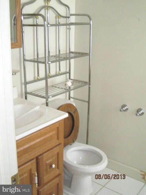 8009 Shore Road Baltimore, MD 21222 - Photo 16 of 19 a bathroom with a toilet and a sink
