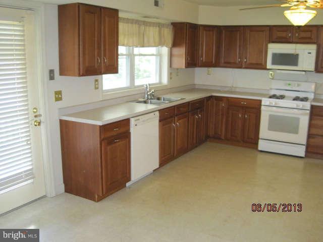 8009 Shore Road Baltimore, MD 21222 - Photo 9 of 19 a kitchen with a sink stove top oven and cabinets