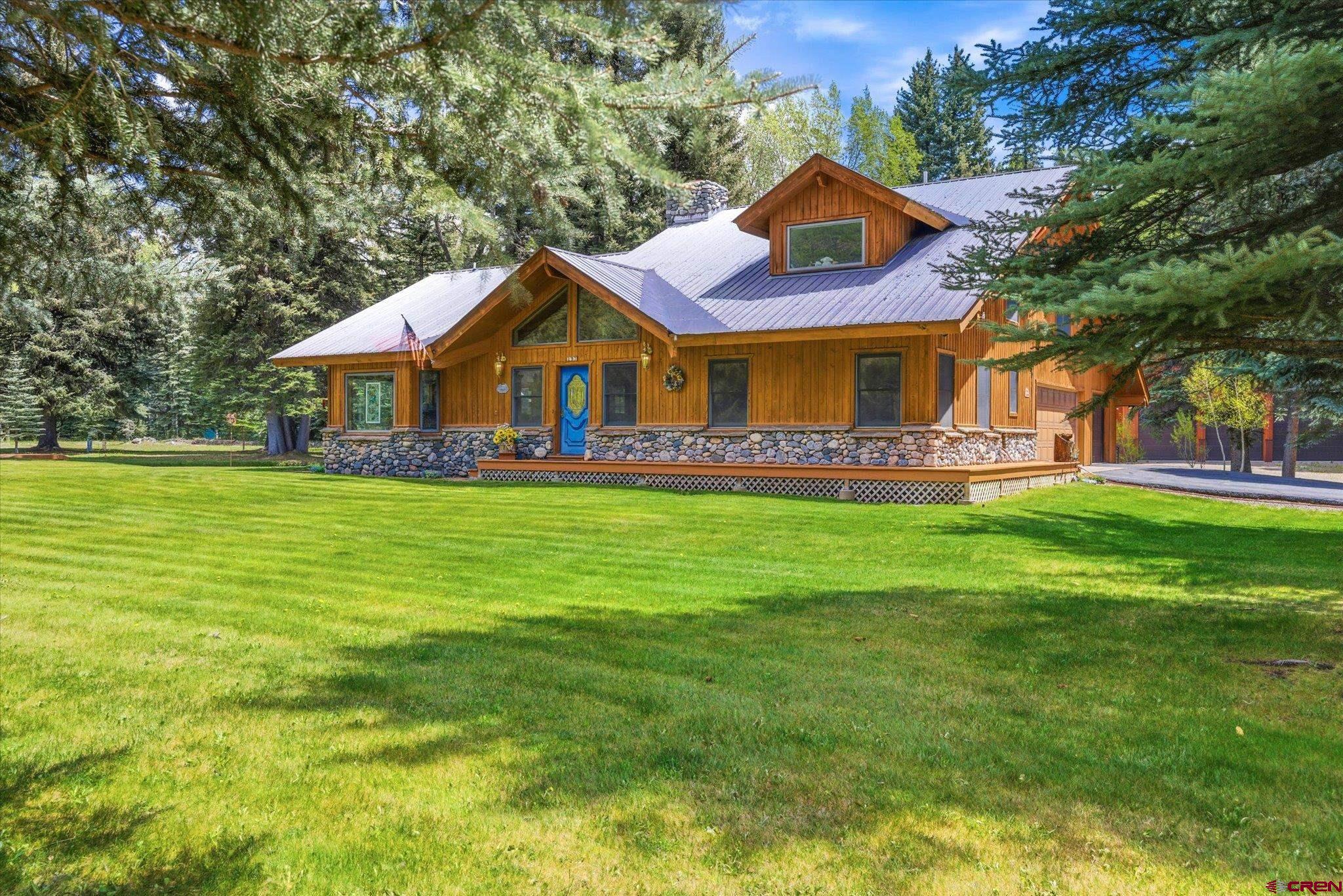 197 Hummingbird Way Bayfield, CO 81122 - Photo 3 of 44 a front view of a house with a garden