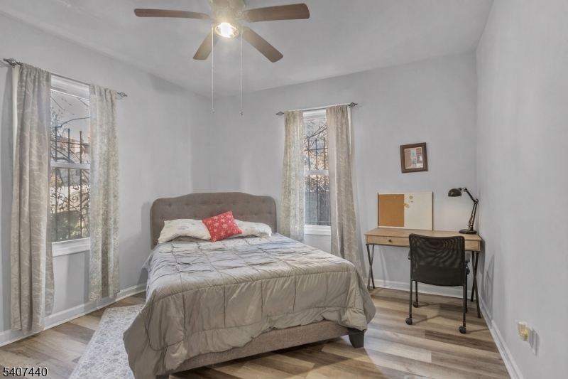 105 Huntington Terrace Newark, NJ 07112 - Photo 18 of 20 a bedroom with a bed a chair and next to a window
