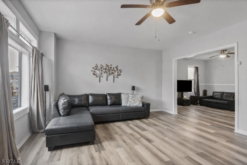 105 Huntington Terrace Newark, NJ 07112 - Photo 3 of 20 a living room with furniture and a chandelier