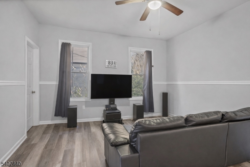 105 Huntington Terrace Newark, NJ 07112 - Photo 4 of 20 a living room with furniture and a flat screen tv