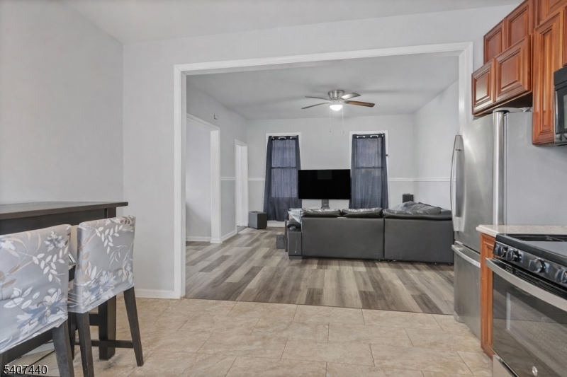 105 Huntington Terrace Newark, NJ 07112 - Photo 7 of 20 a living room with furniture and a flat screen tv