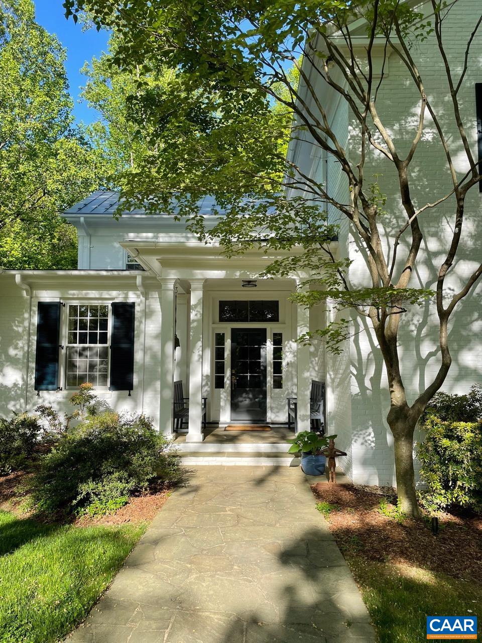1929 Blue Ridge Road Charlottesville, VA 22903 - Photo 4 of 44 a view of a house with large windows and a tree