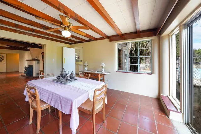 a view of a dining room with furniture and window