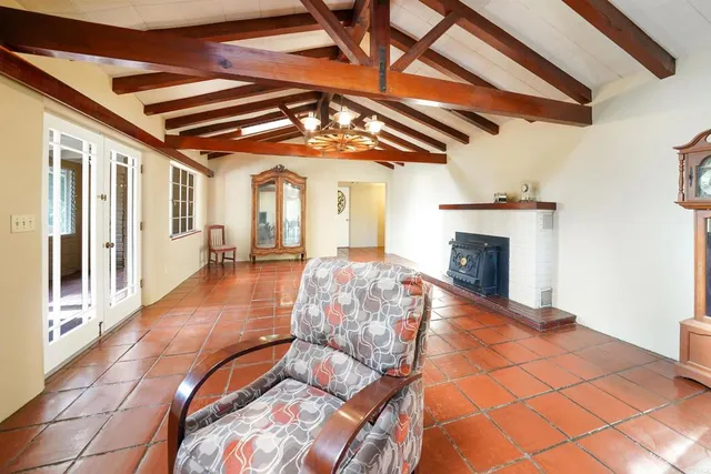 a roof deck with fireplace and wooden floor