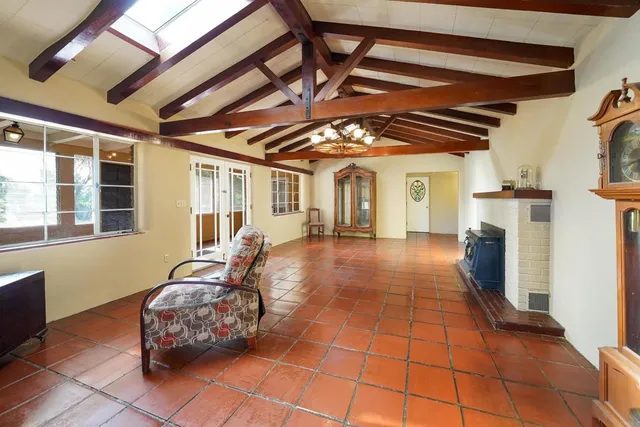 a spacious bedroom with a bed and a window