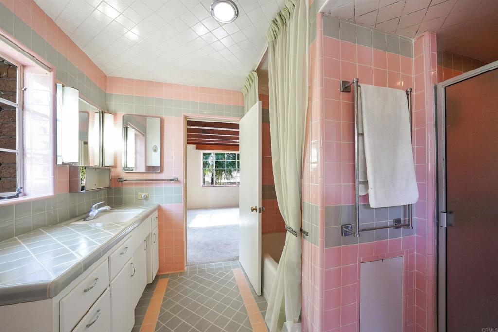 1077 Pine Street Ramona, CA 92065 - Photo 19 of 51 a bathroom with a granite countertop sink a mirror and a shower