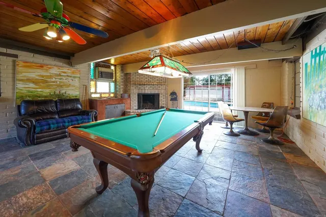 a room with patio furniture and a fireplace