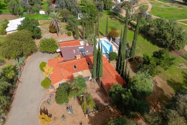 an aerial view of residential houses with outdoor space