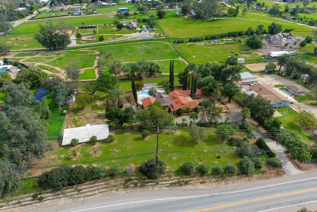 a view of a house with yard and sitting area